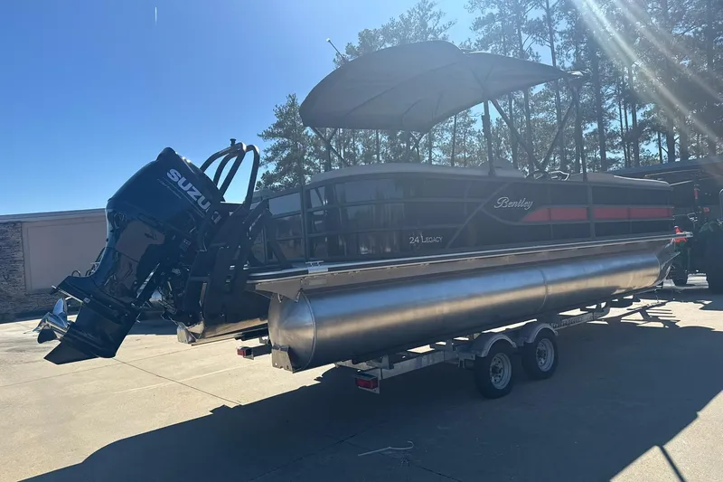 Slide: The Image of 2026 Bentley Pontoons Legacy 243 Navigator on trailer, featuring Suzuki outboard motor. - 3