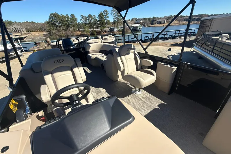 Slide: The Image of 2026 Bentley Pontoons Legacy 243 Navigator interior with luxurious seating and steering wheel. - 7