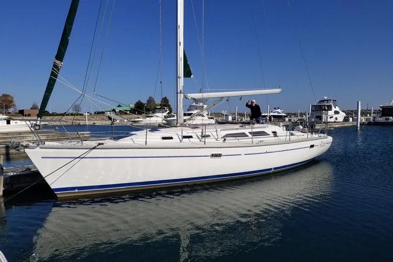 The Image of Sailboat Catalina 400, 1999 model, docked in a marina under clear blue skies. - 0