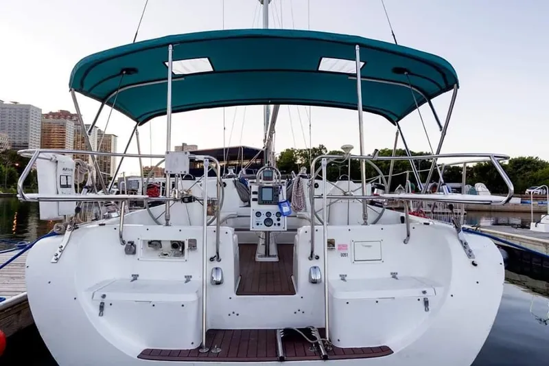 Slide: The Image of Stern view of a 1999 Catalina 400 sailboat docked at a marina. - 3