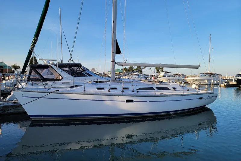Slide: The Image of 1999 Catalina 400 sailboat docked in a marina under clear blue skies. - 8