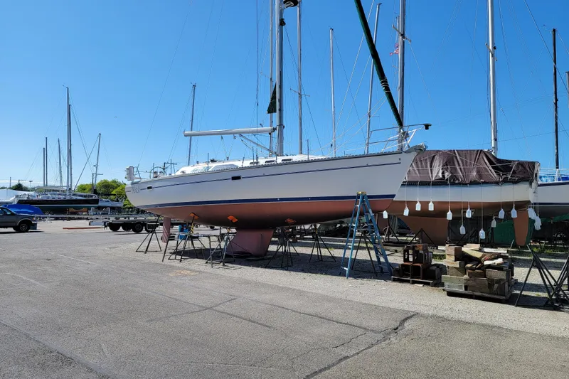 Slide: The Image of 1999 Catalina 400 sailboat on stands in a marina, clear blue sky background. - 9