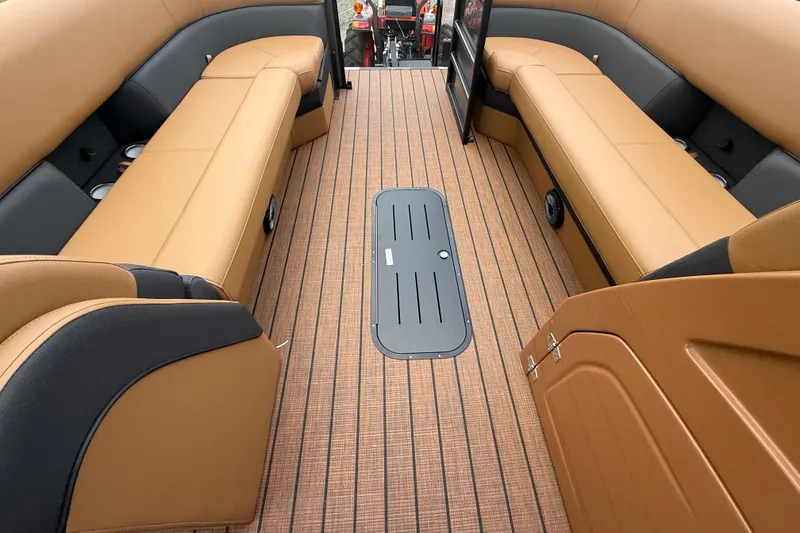 Slide: The Image of 2026 Bentley Pontoons Elite 253 Admiral interior with tan seating and wood-patterned flooring. - 10