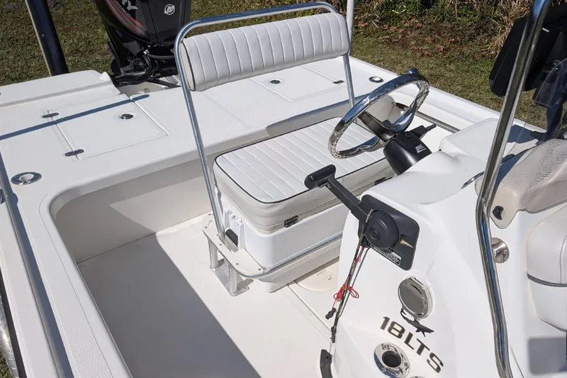 Slide: The Image of 2015 Mako 18 LTS boat interior with steering wheel and seating. - 11