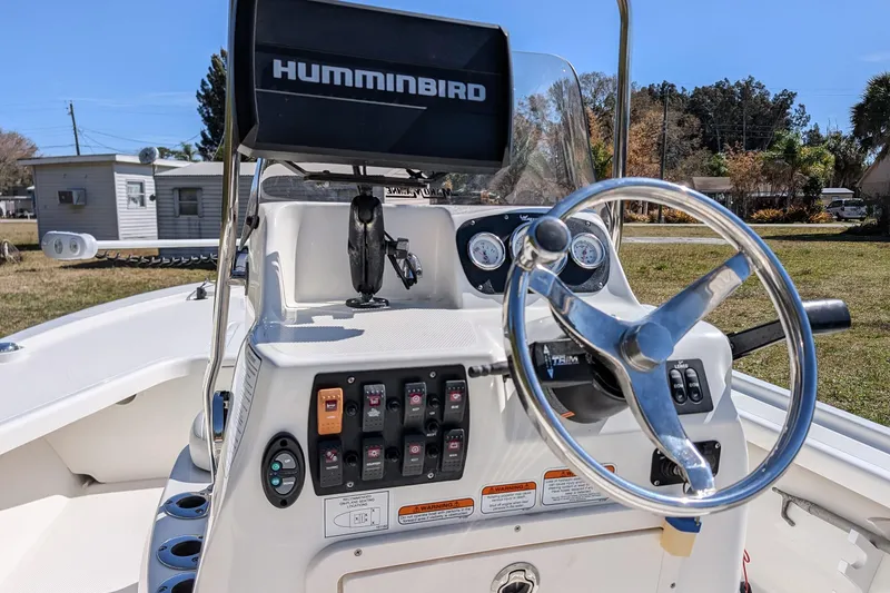 Slide: The Image of 2015 Mako 18 LTS boat console with steering wheel and Humminbird electronics. - 12