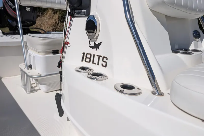Slide: The Image of 2015 Mako 18 LTS boat interior with rod holders and seating. - 16
