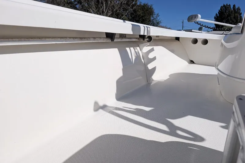 Slide: The Image of 2015 Mako 18 LTS boat interior with clean white deck and railing. - 17
