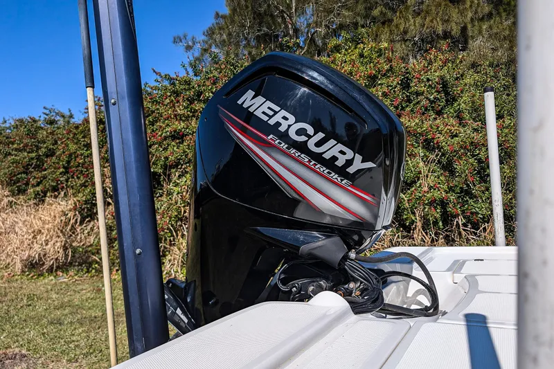 Slide: The Image of Mercury FourStroke engine on a 2015 Mako 18 LTS boat, outdoors. - 19