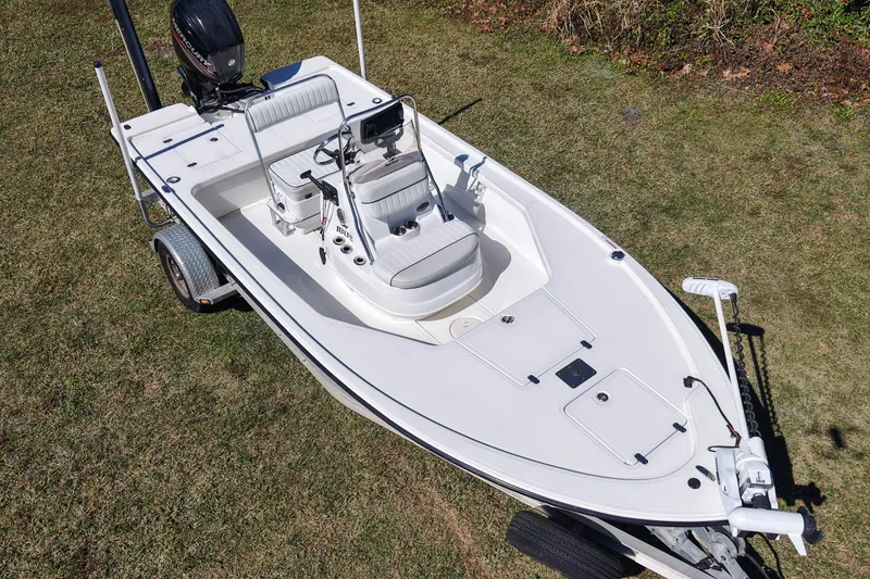 Slide: The Image of 2015 Mako 18 LTS boat on trailer, parked on grass, aerial view. - 8
