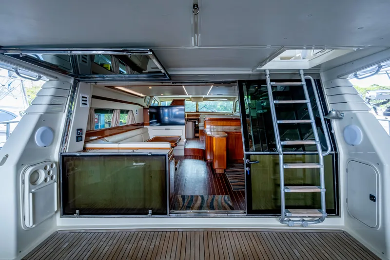 Slide: The Image of Luxurious interior of a 1997 Ferretti Yachts 650, featuring elegant wood finishes and modern amenities. - 12