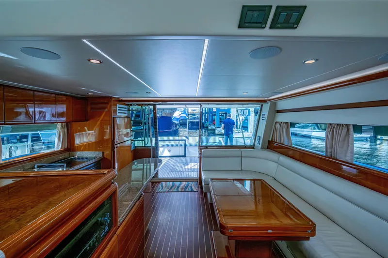 Slide: The Image of Luxurious interior of a 1997 Ferretti Yachts 650 with elegant wood finishes and spacious seating. - 21