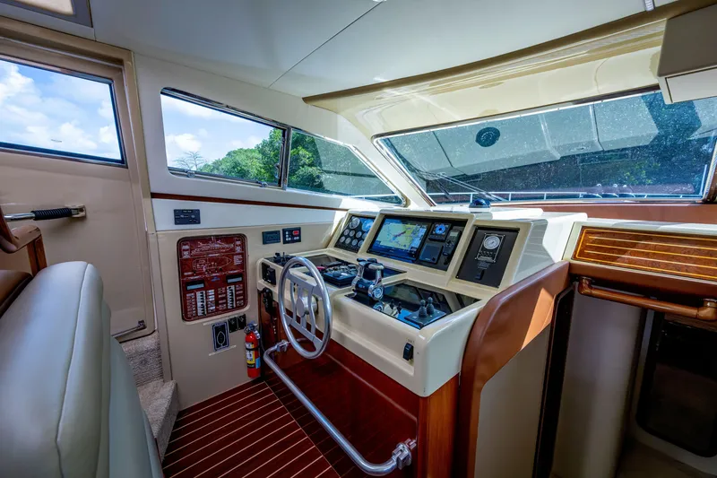 Slide: The Image of Interior cockpit of a 1997 Ferretti Yachts 650, featuring navigation controls and luxurious design. - 24