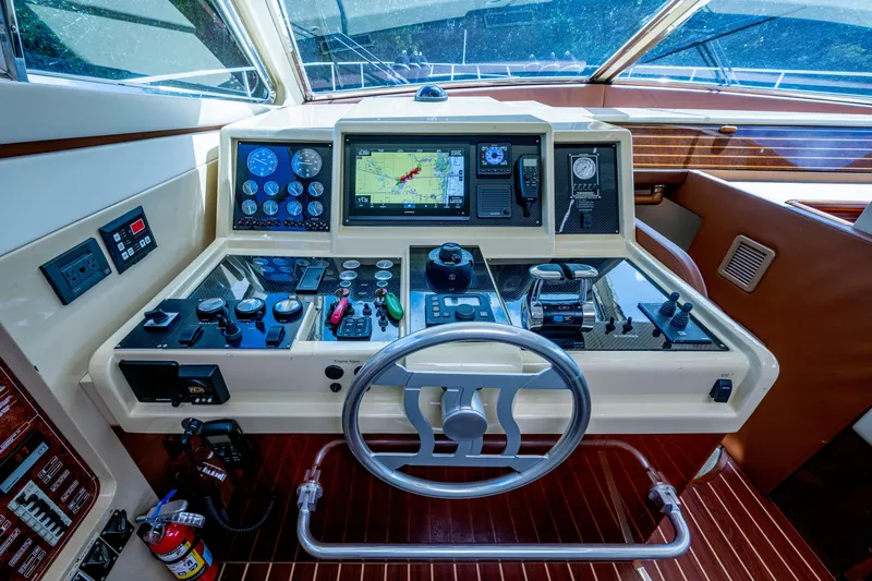 Slide: The Image of Cockpit of 1997 Ferretti Yachts 650 with navigation controls and steering wheel. - 25