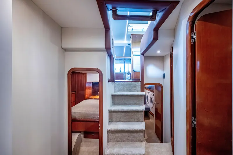 Slide: The Image of Interior of 1997 Ferretti Yachts 650, featuring stairs, bedroom, and laundry area. - 33