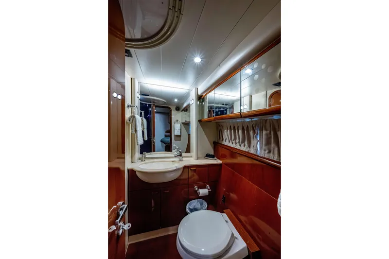 Slide: The Image of Luxurious bathroom interior of a 1997 Ferretti Yachts 650, featuring elegant wood finishes. - 41