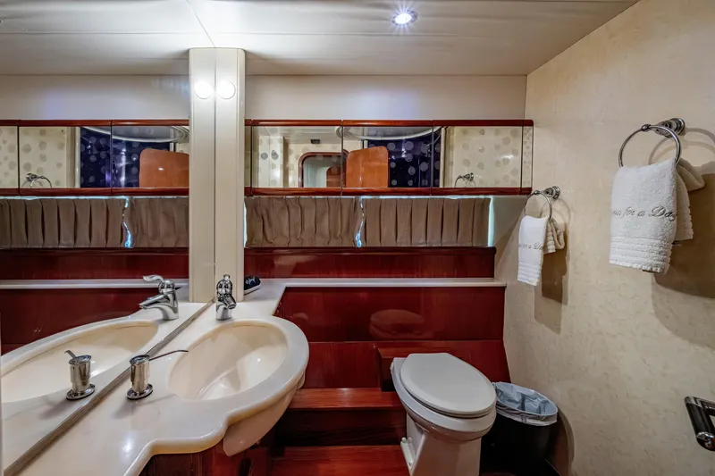 Slide: The Image of Luxurious bathroom interior of a 1997 Ferretti Yachts 650, featuring dual sinks and elegant wood finishes. - 44