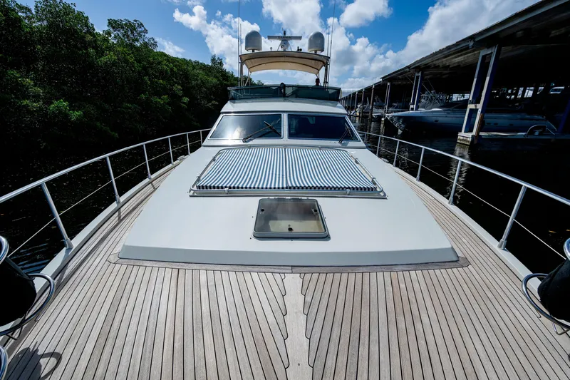 Slide: The Image of 1997 Ferretti Yachts 650, docked, showcasing sleek deck design under blue sky. - 6