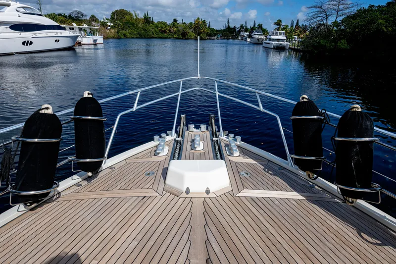 Slide: The Image of Bow view of 1997 Ferretti Yachts 650 on calm water, surrounded by other yachts. - 7