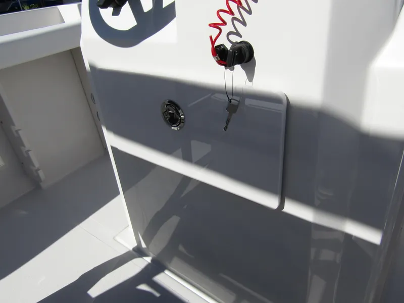 Slide: The Image of 2024 Starcraft SVX 191 OB CC boat console with ignition key and safety lanyard. - 28