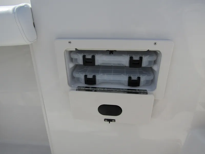 Slide: The Image of 2024 Starcraft SVX 191 OB CC storage compartment with two plastic containers. - 18