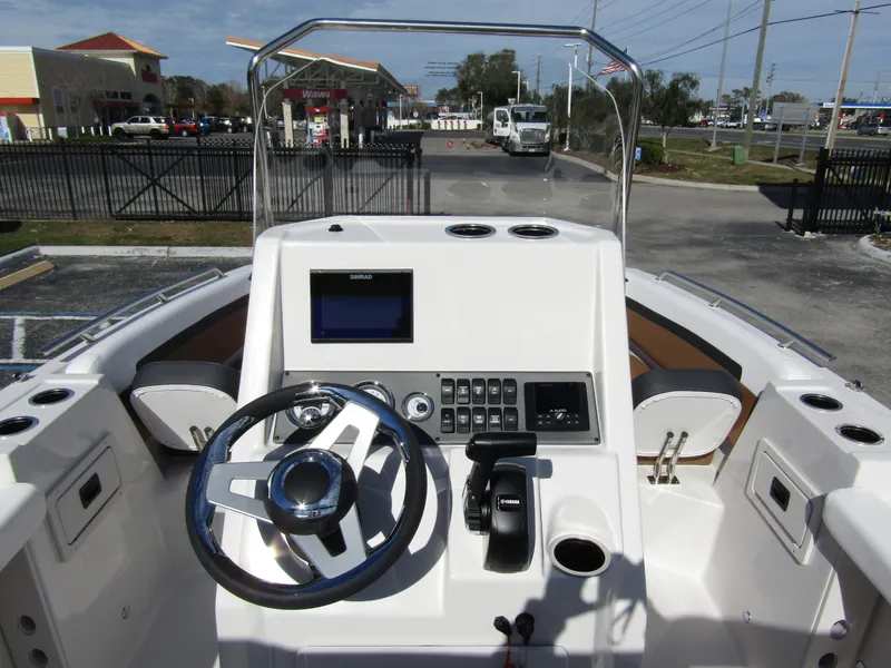 Slide: The Image of 2024 Starcraft SVX 191 OB CC boat console with steering wheel and control panel. - 23