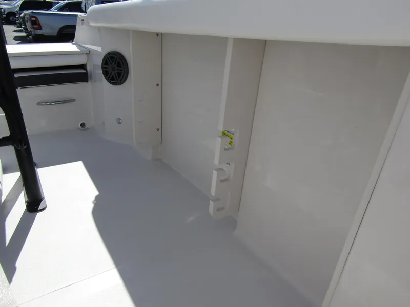 Slide: The Image of 2024 Starcraft SVX 191 OB CC boat interior, featuring storage compartments and speaker. - 19