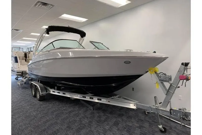 The Image of 2019 Regal 2500 Bowrider on trailer in showroom, sleek design, modern features. - 0