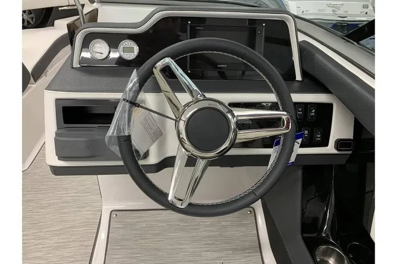 Slide: The Image of Steering wheel and dashboard of 2019 Regal 2500 Bowrider boat, featuring modern controls. - 12