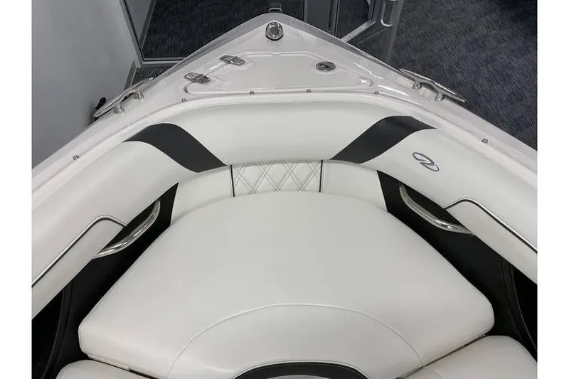 Slide: The Image of 2019 Regal 2500 Bowrider boat interior with white cushioned seating and sleek design. - 18