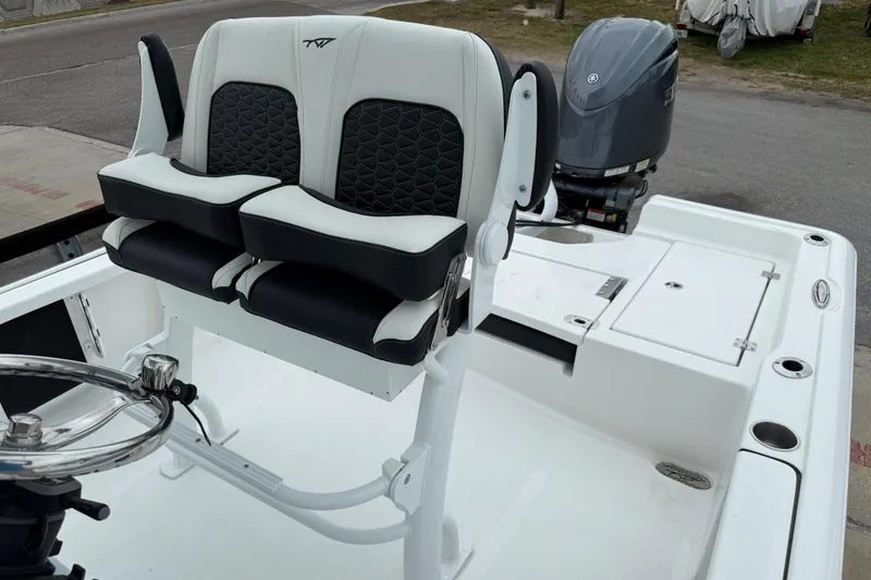 Slide: The Image of 2026 Tidewater 2210 Carolina Bay boat interior with dual seats and steering wheel. - 10