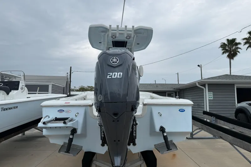 Slide: The Image of 2026 Tidewater 2210 Carolina Bay boat with Yamaha 200 engine, docked outdoors. - 4