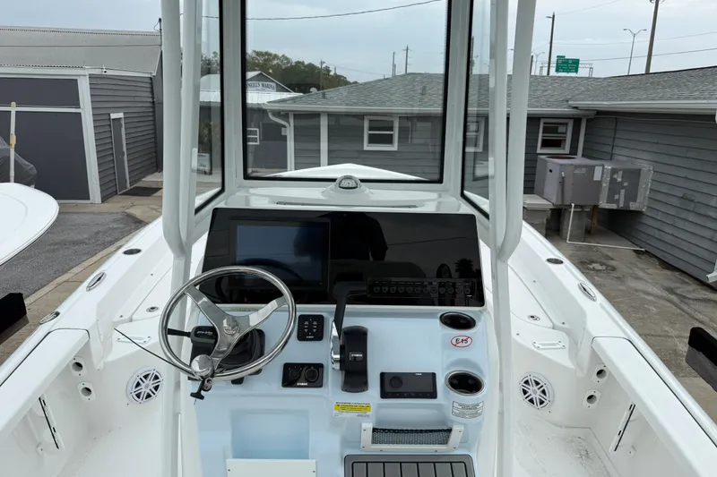 Slide: The Image of 2026 Tidewater 2210 Carolina Bay boat console with steering wheel and navigation display. - 6