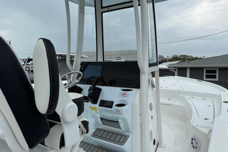 Slide: The Image of 2026 Tidewater 2210 Carolina Bay boat interior with steering console and seating. - 7