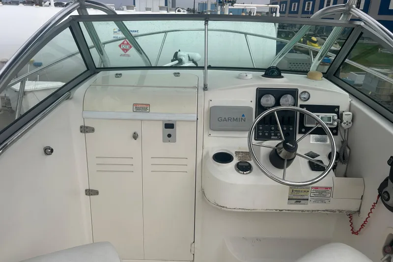 Slide: The Image of 2005 Boston Whaler 205 Eastport boat dashboard with Garmin navigation system and steering wheel. - 10