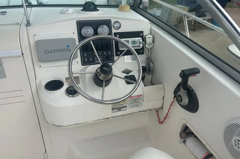 Slide: The Image of 2005 Boston Whaler 205 Eastport boat dashboard with Garmin navigation system. - 11