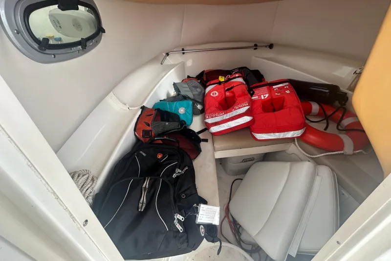 Slide: The Image of Interior of 2005 Boston Whaler 205 Eastport with life jackets and bags. - 12