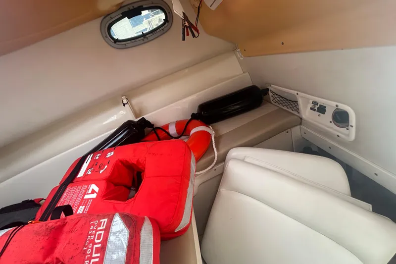 Slide: The Image of Interior of 2005 Boston Whaler 205 Eastport with life jackets and seating. - 13