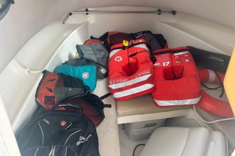 Slide: The Image of Interior of 2005 Boston Whaler 205 Eastport with life jackets and bags. - 14