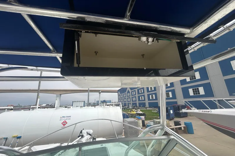 Slide: The Image of 2005 Boston Whaler 205 Eastport boat with open storage compartment, dockside view. - 15