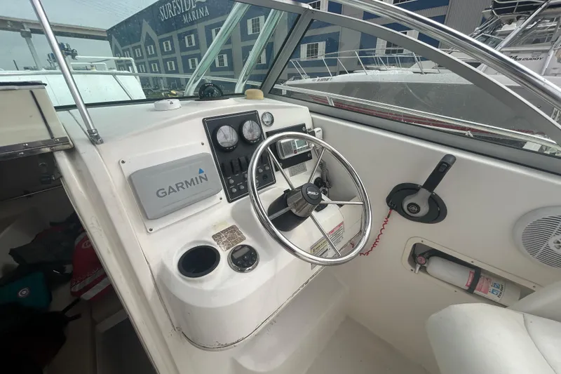 Slide: The Image of 2005 Boston Whaler 205 Eastport boat cockpit with Garmin navigation system and steering wheel. - 16