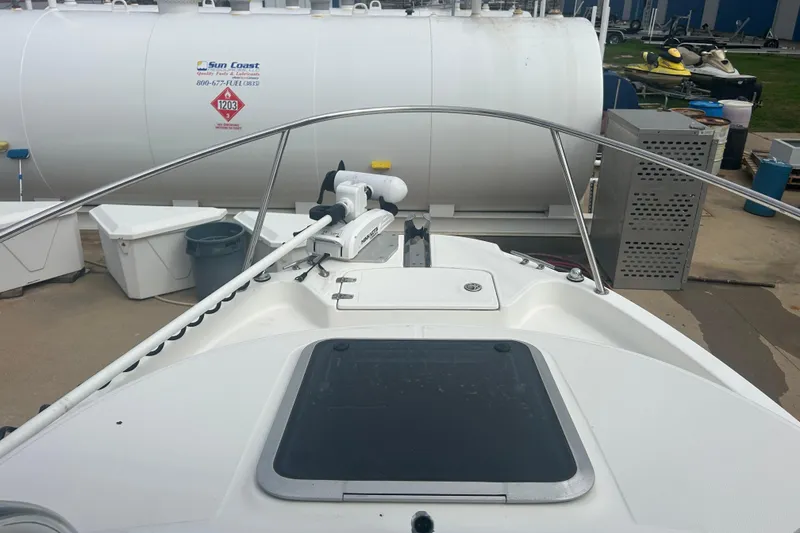 Slide: The Image of 2005 Boston Whaler 205 Eastport boat docked near fuel tanks. - 19