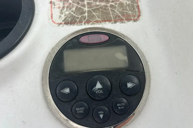 Slide: The Image of Control panel on a 2005 Boston Whaler 205 Eastport boat, featuring volume and navigation buttons. - 23