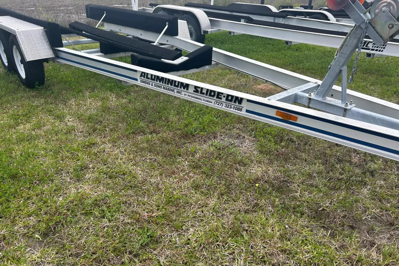 Slide: The Image of Aluminum boat trailer for 2005 Boston Whaler 205 Eastport on grass. - 28