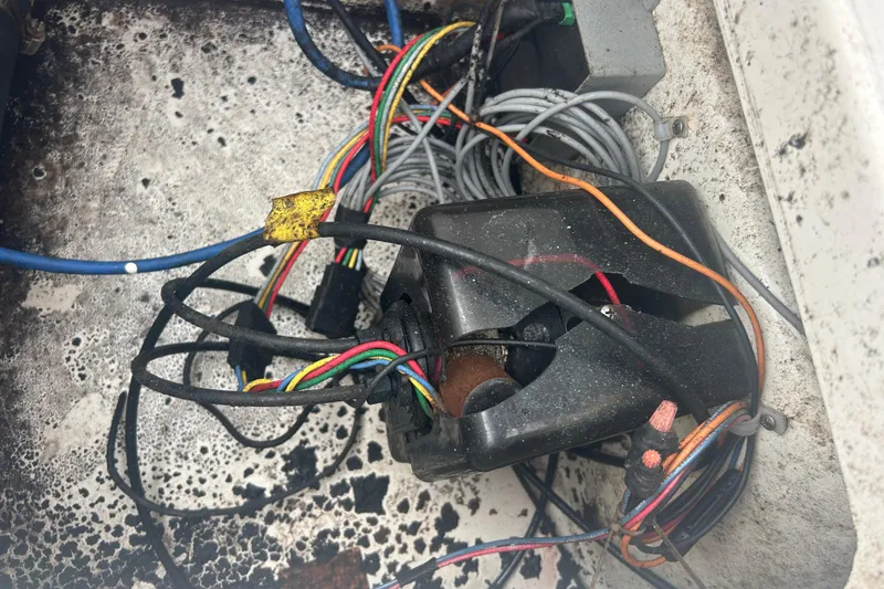 Slide: The Image of Tangled wires and components inside a 2005 Boston Whaler 205 Eastport boat. - 33