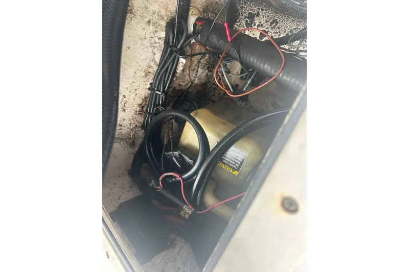 Slide: The Image of 2005 Boston Whaler 205 Eastport engine compartment with wiring and components visible. - 34