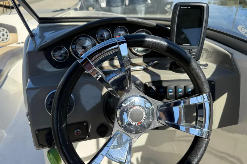 Slide: The Image of Steering wheel and dashboard of 2018 Stingray 204 LR boat with gauges and GPS. - 16