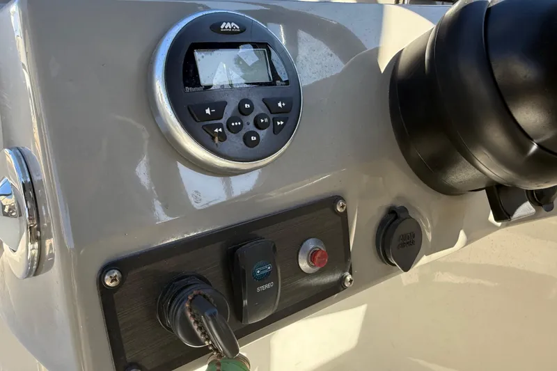 Slide: The Image of Control panel of a 2018 Stingray 204 LR boat with audio system and ignition. - 18