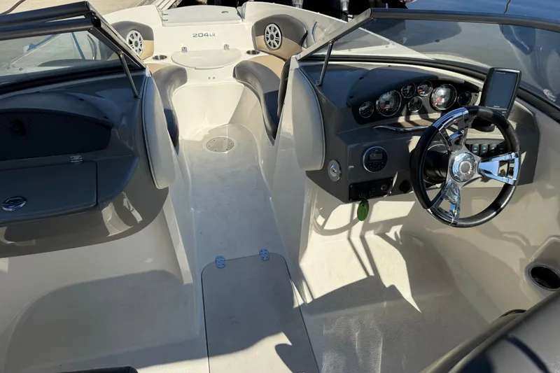 Slide: The Image of 2018 Stingray 204 LR boat interior with steering wheel and dashboard controls. - 27
