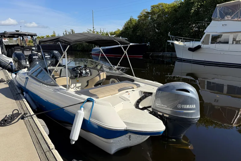 Slide: The Image of 2018 Stingray 204 LR boat docked with Yamaha outboard motor, under sunny skies. - 3