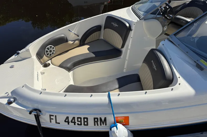 Slide: The Image of 2018 Stingray 204 LR boat with sleek seating and Florida registration. - 6